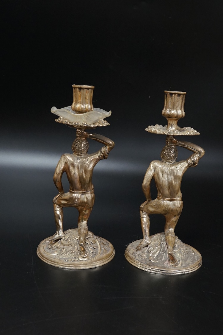 A pair of Blackamoor silvered brass candlesticks, 19cm high